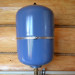 What air pressure should be in the empty DHW expansion tank?