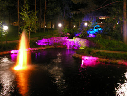 Illuminated fountain in an artificial pond Fountain lights