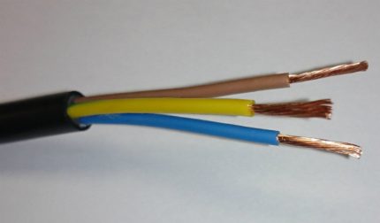 A wire for connecting the outlet for a washing machine in the bathroom Three cores of a current-carrying wire