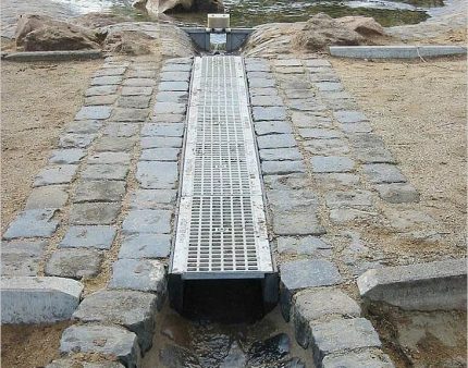 Open drainage with metal grill above the linear water intake Linear drainage
