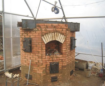 Brick stove in greenhouse heating in winter Greenhouse stone oven