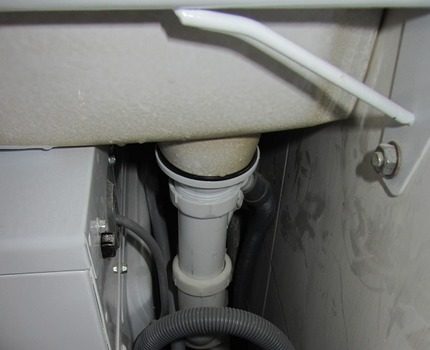 Het externe model van de sifon voor de wasmachine is beter te verbergen achter de badkamer Met behulp van een externe sifon
