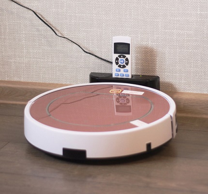Charging a robot vacuum cleaner in a parking lot Charging the robot at the parking base