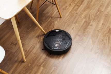 Robot vacuum cleaner in the kitchen Robot vacuum cleaner at work