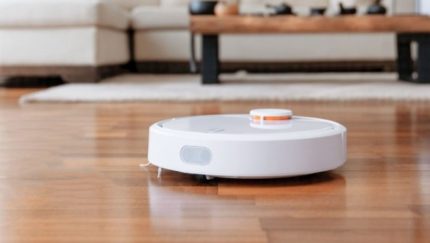 Cleaning smooth and fleecy floors White robot vacuum cleaner