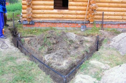 La construction de la boucle de mise à la terre à la maison Boucle au sol près d'une maison en bois