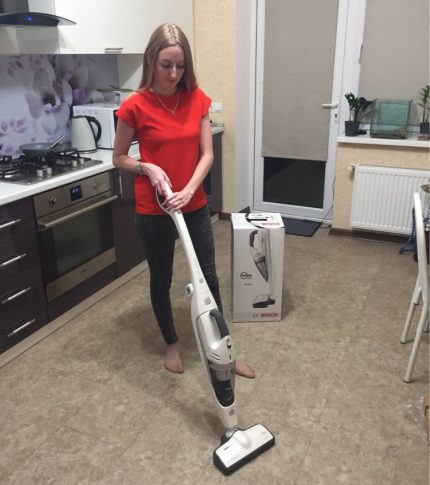 A vertical vacuum cleaner will help attract teenagers to cleaning Girl cleans the room