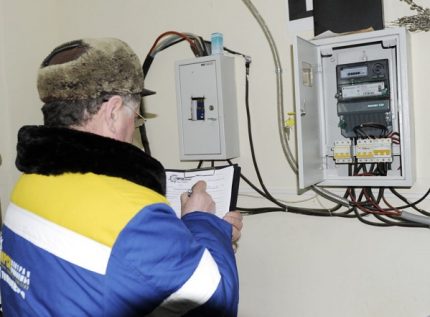 A representative of an energy company takes a meter reading The specialist takes a meter reading