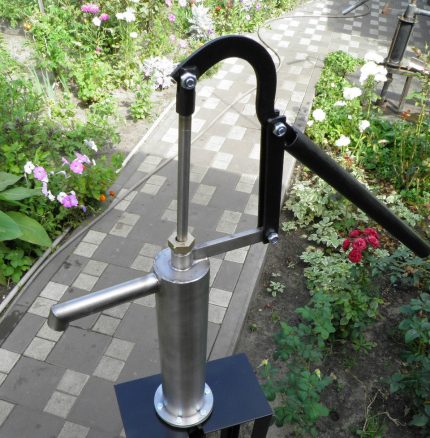 Hand pump in metal housing Hand pump in the garden