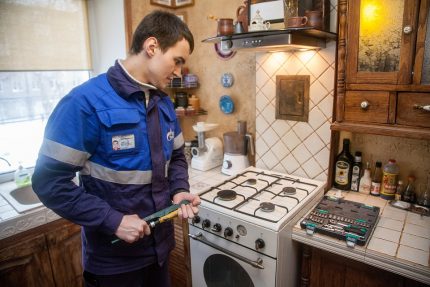 Gasman repairs the stove