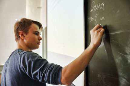 Pupil writes on the blackboard Pupil writes on the blackboard