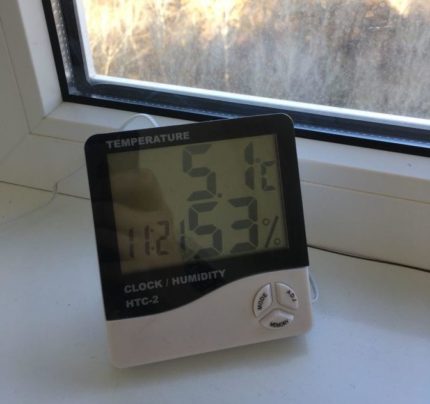 Electronic hygrometer on the window Electronic hygrometer on the window